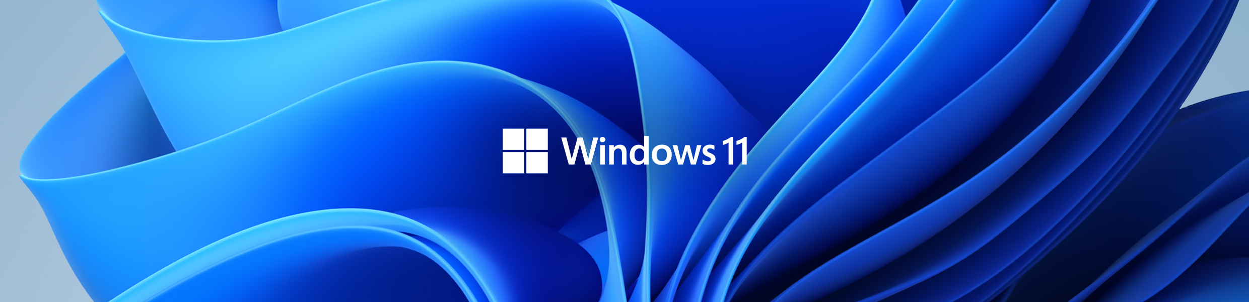 Windows 11 Windows 11-tekst i hvitt foran en livlig, blå bakgrunn