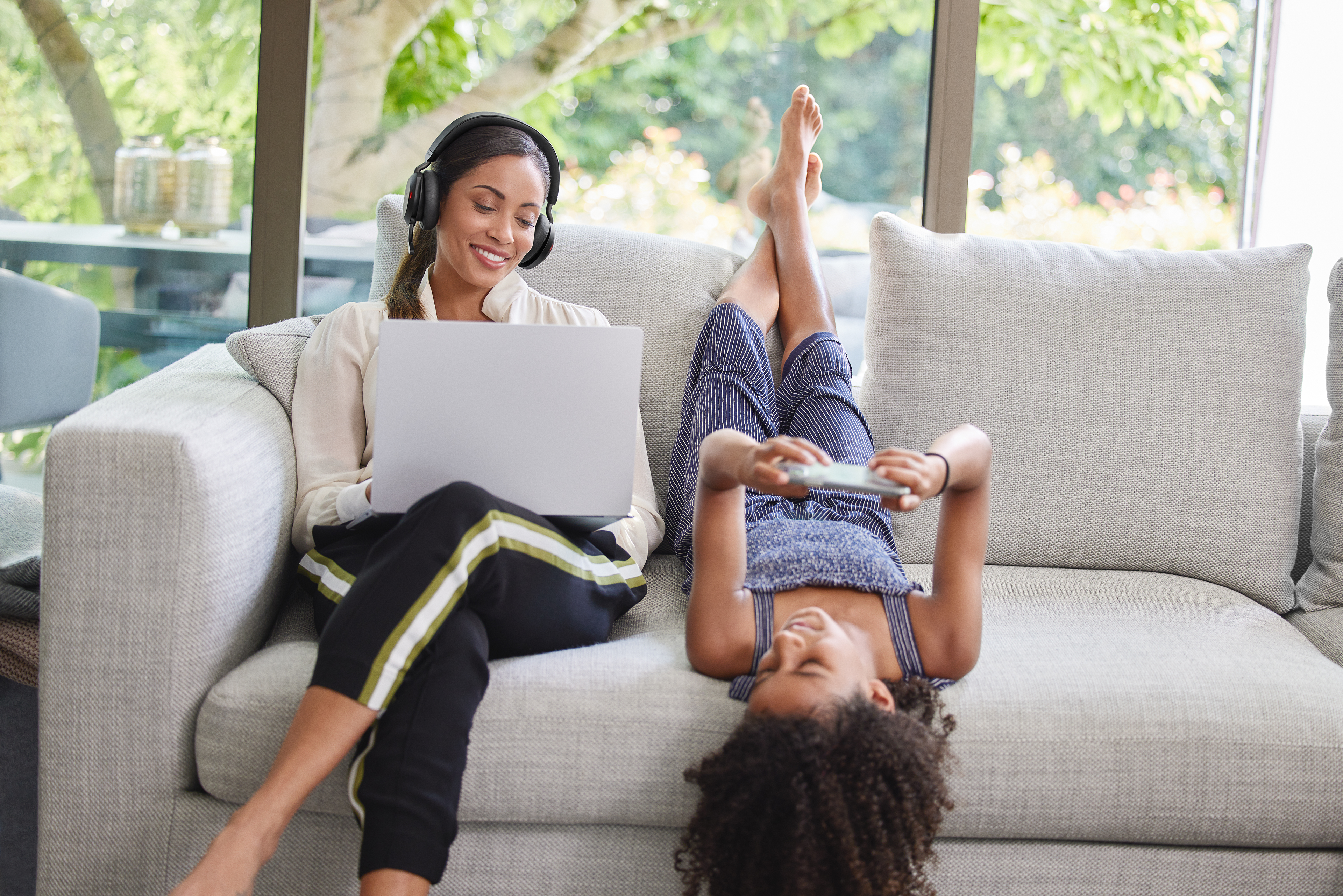 Jabra - Woman with Evolve2 75 on sofa with kid