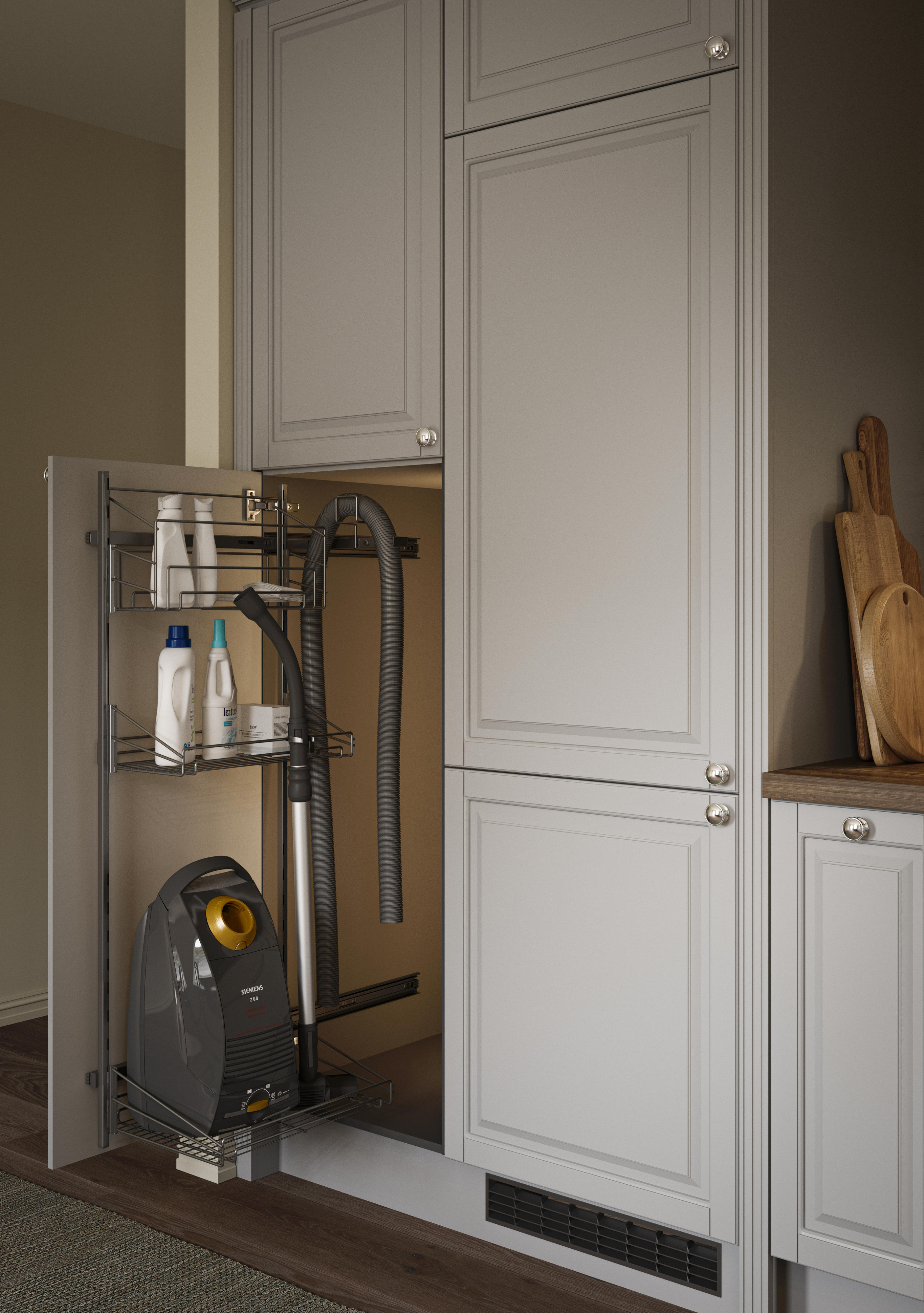 En åpen dør med en uttrekkbar løsning som holder støvsuger og vaskemidler i et Epoq Heritage Light Grey kjøkken