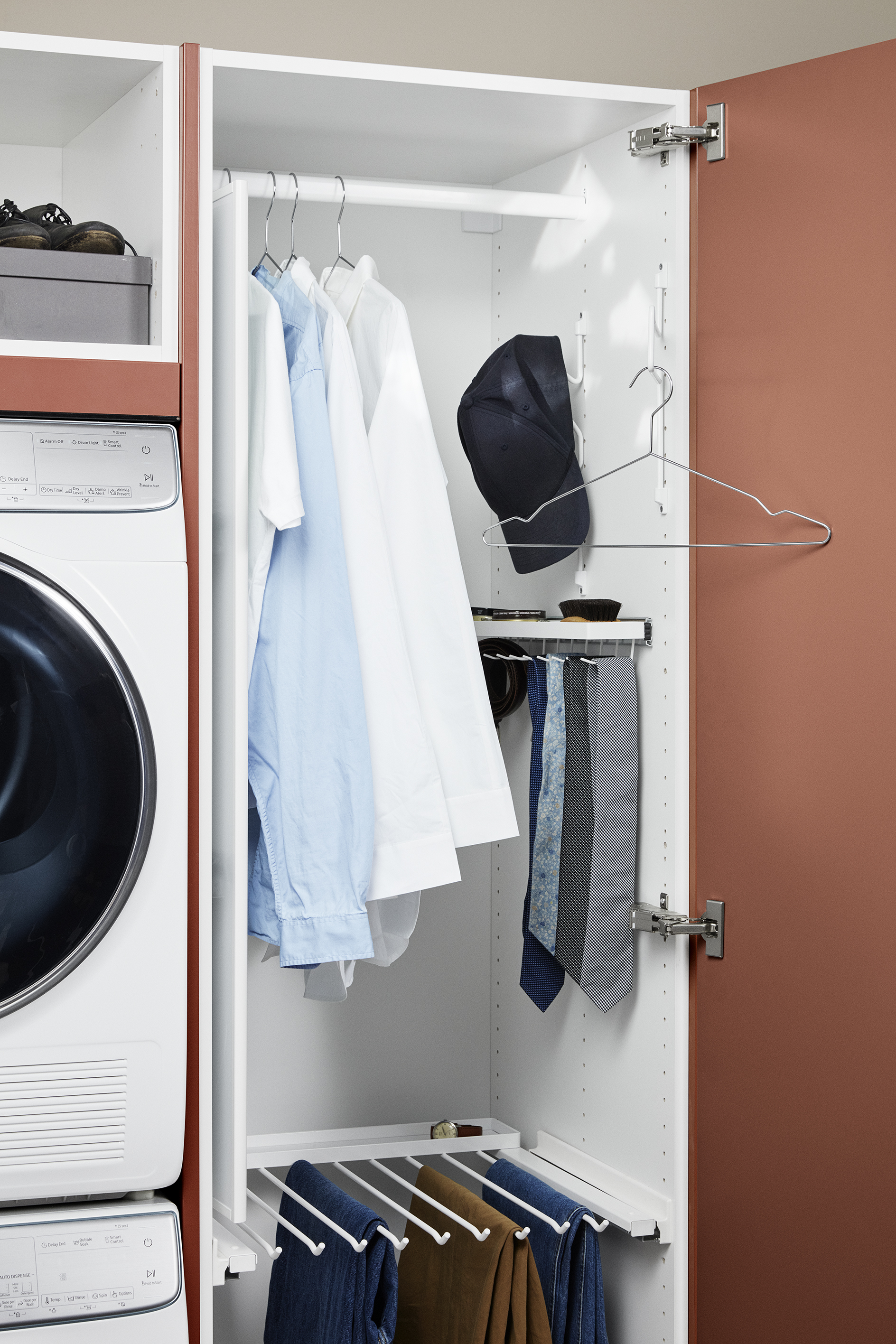 Tall cabinet with hangers in a laundry room