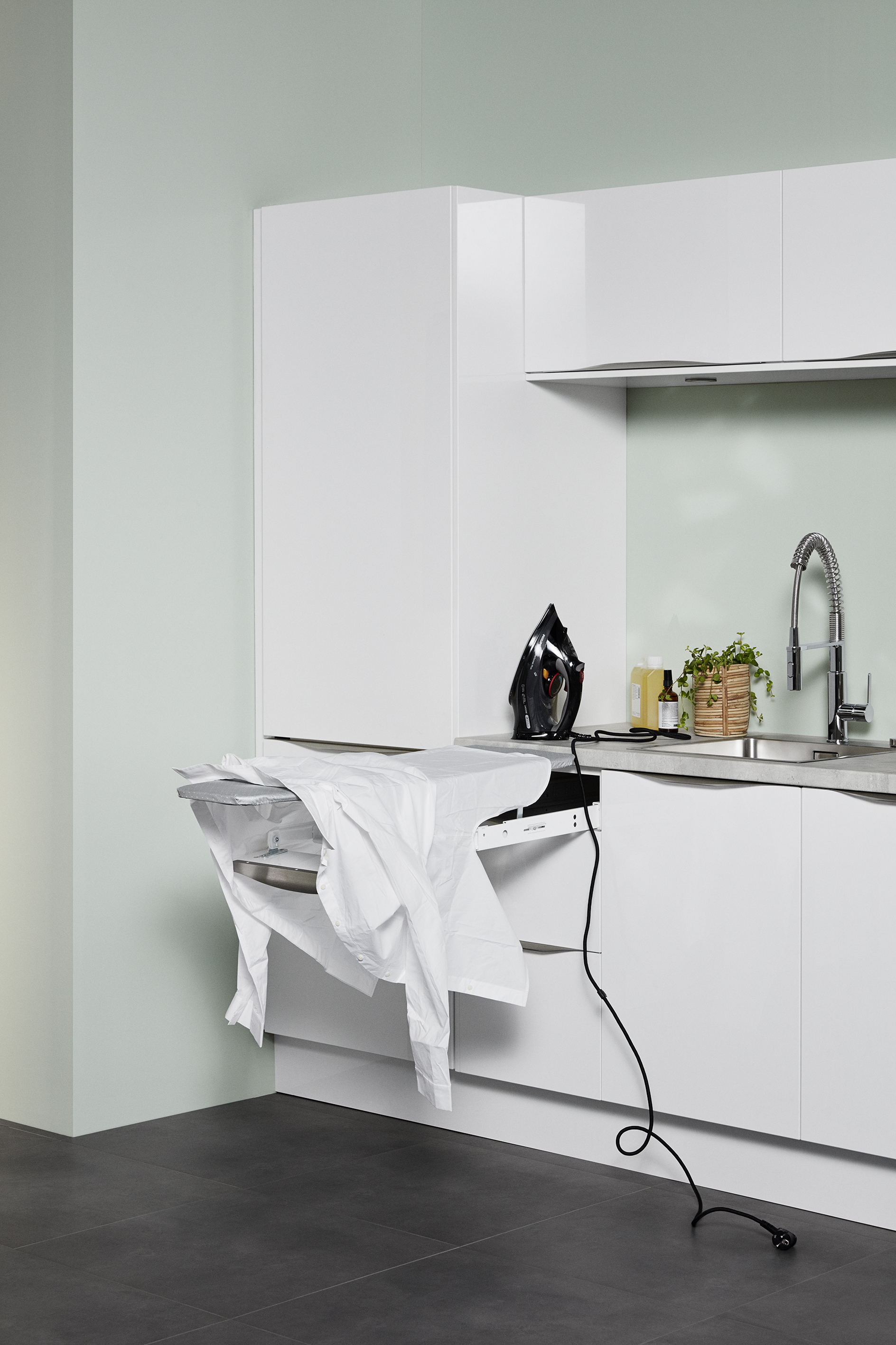 Expendable iron board in a laundry room