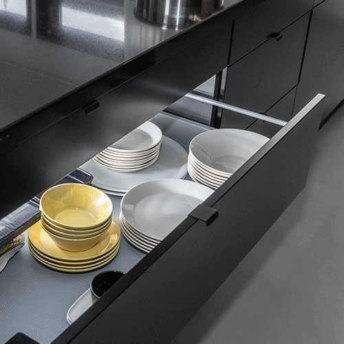 Open kitchen drawer with plates in them
