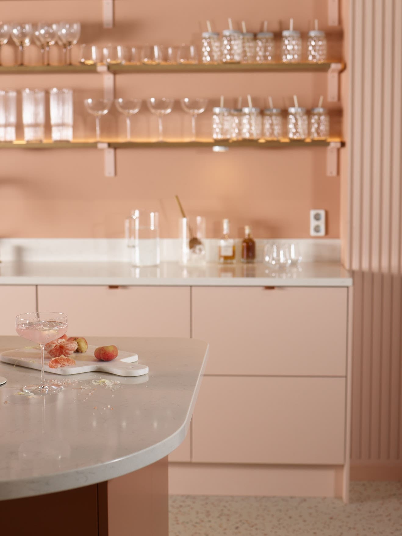 Trend blush colored kitchen and glasses on a shelf