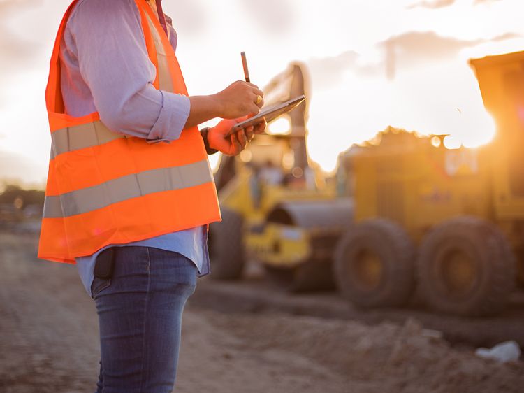 Man using stylus on tablet at construction site