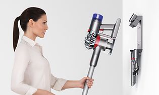Dame som setter Dyson V8-støvsuger i dokkingstasjon