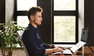 man-working-on-a-laptop-and-using-contour-keyboard-and-rollermouse