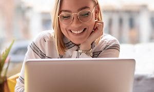 Smiling woman working with a laptop