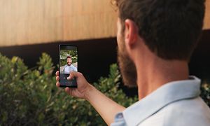 Mann tar et bilde med sin Motorola Edge 20-telefon