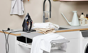 Fold in ironing board in an Epog laundry room.