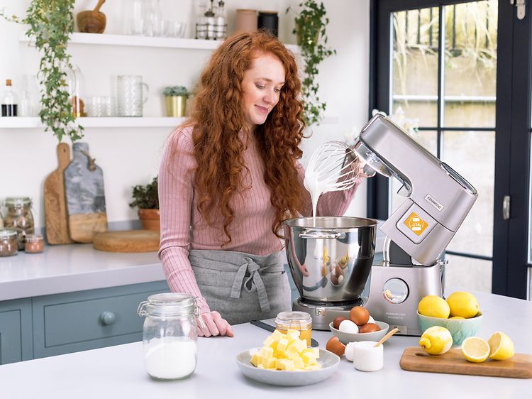 SDA-Kitchen machines-Woman with Kenwood kitchen machine in steel in a kitchen