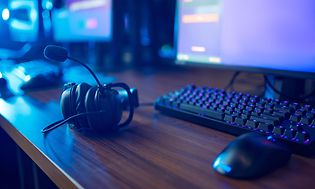 Gaming headset, keyboard and mouse on desk