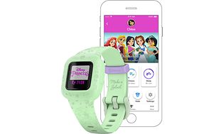 Produktbilde av Garmin Vivofit Jr. 3 i grønt med Disney-prinsesser på en mobil i bakgrunnen