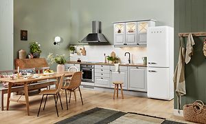 White EPOQ Heritage kjøkken i en åpen kjøkkenløsning med spisebord, kjøkkenvifte og kjøleskap