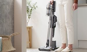 Woman using a cordless vacuum cleaner
