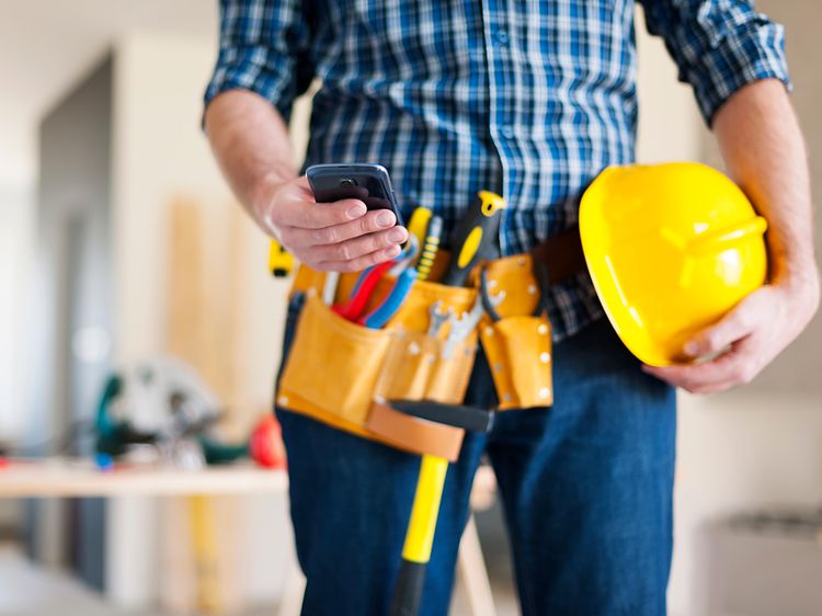 storyblocks-close-up-of-construction-worker-with-mobile-phone_Sb7-mCw5z