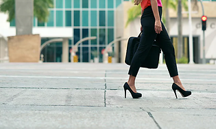 woman walking while holding a briefcase (1)