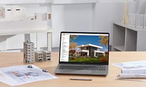 MSI Creator Z16P på et skrivebord med arkitekttegninger