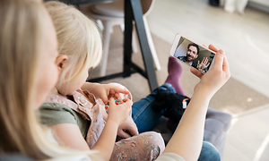 kvinne og en liten jente snakker med en mann på videosamtale