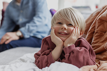 Five tips for buying a new TV:  Happy kid and his family in the background.