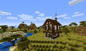 En hytte bygget i Minecraft ved siden av en elv