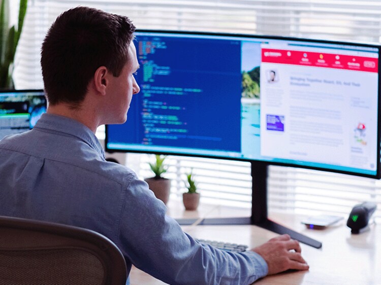 man sitting in front of pc screen