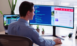 man sitting in front of pc screen