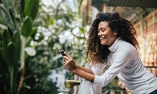 Laughing woman using her phone