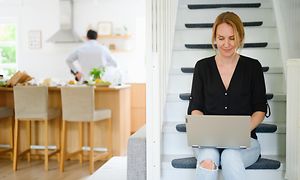 Woman typing in the staircase