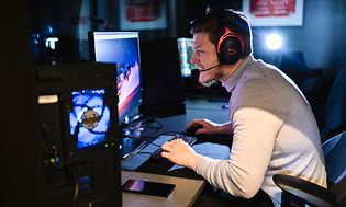 Man playing on a desktop gaming pc