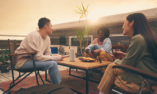 Sony-People around table with Sony speaker