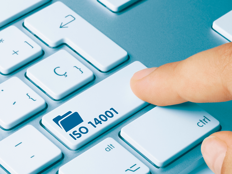 A finger pressing a key on a keyboard with a file symbol and the text ISO 14001