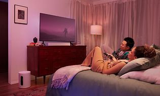 Couple watching TV in bed