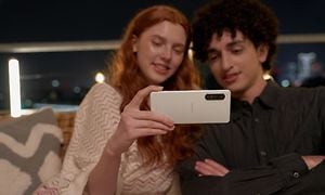 Man and woman looking at a Sony Xperia phone