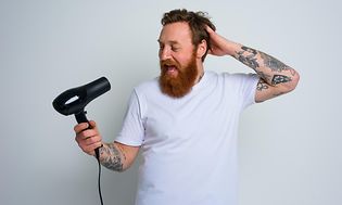 Man singing into hair blower