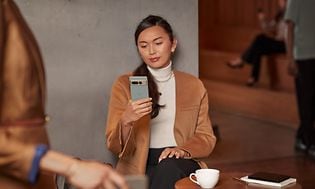 Woman looking at Pixel phone