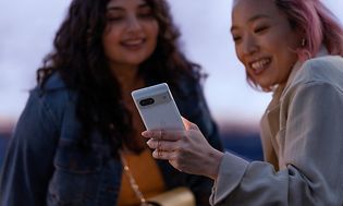 Two girls looking at a Google Pixel 7 phone