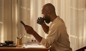 Man talking in phone with Google Pixel Buds