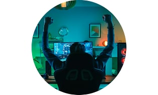 CS-Gaming insurance- Man raising hands while gaming