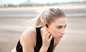 Woman with Bose headphones on beach