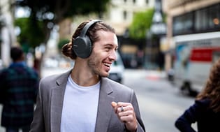 Man on street with Sony around-ear headphones