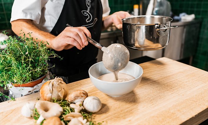 SDA - Cooking - chef pouring vegetable soup from a pot to a bowl