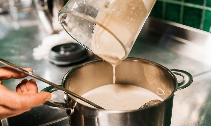 SDA - Cooking - vegetable soup in a blender being poured into a pot