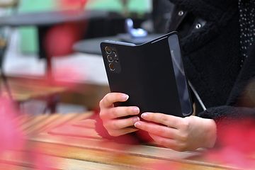Telecom - Change Android old to new . A person holding a phone against a table