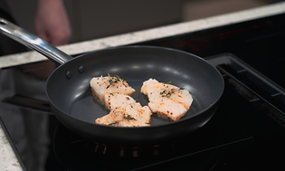 Fish being fried on a frying pan