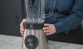 SDA - Blender - A woman holding a blender on a table