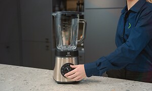 SDA - Blender - A woman turning the power knob on a blender