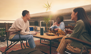 People outside with speaker on table