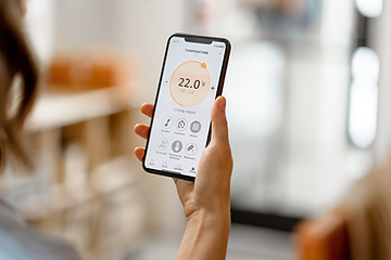 Indoor Climate: Woman measuring air quality with an app.