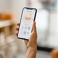 Indoor Climate: Woman measuring air quality with an app.
