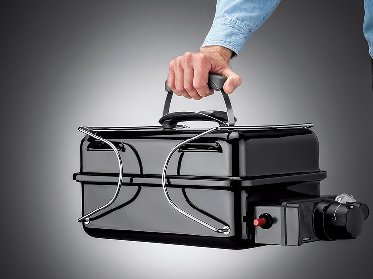Man holding portable grill